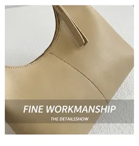 Detailed close-up of smooth beige leather texture and fine stitching on the stylish hobo bag
