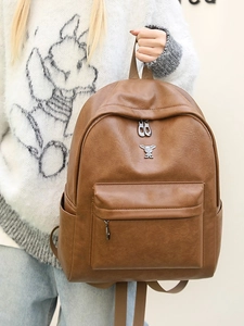 Vintage brown PU leather backpack with decorative metal rabbit head and zipper pockets