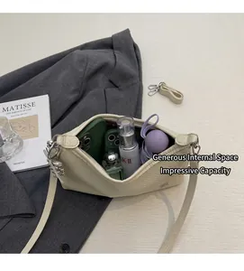 Macro detail of beige pebble leather shoulder bag showing spacious interior for essentials