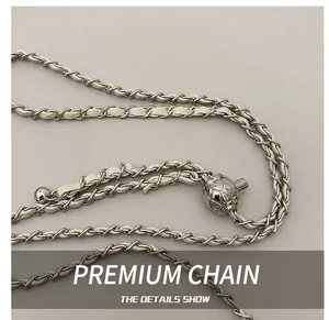 Close-up of beige leather chain strap with silver tone metal ball adjustment bead