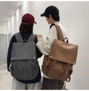 Detail view of the drawstring closure and metal buckle on matte PU leather backpack