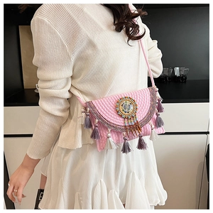 Detail of pink bohemian crochet crossbody bag with mandala beadwork and colorful tassels