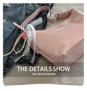 Detail of pink PU shoulder bag featuring silver buckle and decorative lace ribbon and heart charm