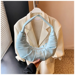 Close-up of light blue pleated dumpling bag with textured vegan leather finish