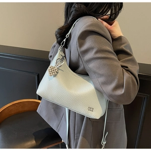 Detail of light blue pebble leather hobo bag with silver heart bead charm and metal logo