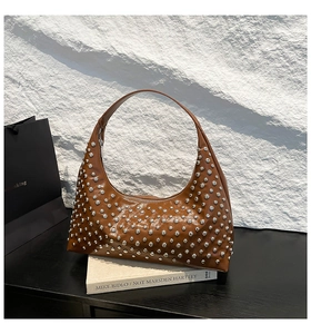 Close-up detail of silver dome studs on premium brown leather punk hobo shoulder bag