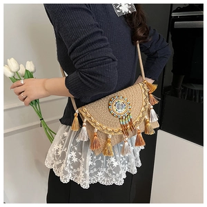 Detail of bohemian woven crossbody bag with colorful beaded totem and fringe tassels