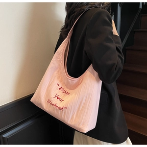 Detailed back view of pink large canvas hobo bag with Enjoy Your Weekend embroidery