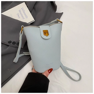 Close-up of light blue lychee pattern leather bucket bag with golden twist lock detail