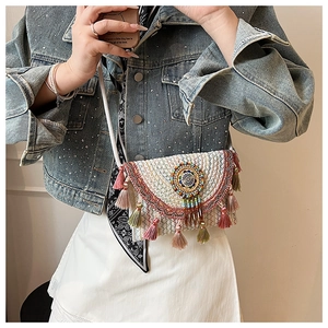 Detail of bohemian woven crossbody bag with colorful tassels and beadwork embroidery