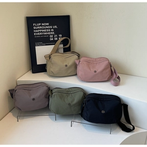 Five assorted nylon crossbody bags featuring multi-layer zippers and adjustable straps