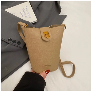 Detail of lychee textured leather bucket bag with gold twist lock and HOCOMU logo