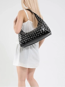 Chic black hobo bag with silver metallic studs and glossy finish on model