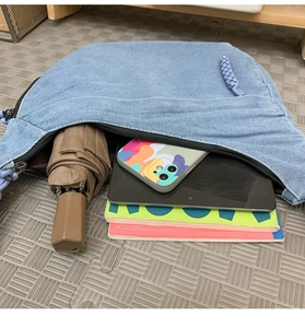 Macro detail of spacious light blue denim tote bag interior showing large capacity storage