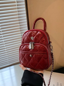 Burgundy patent leather mini crossbody bag with diamond quilting and silver floral buckle