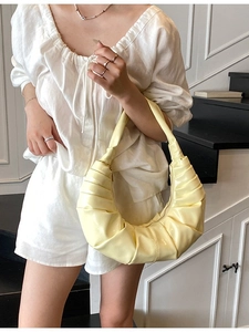 Chic light yellow ruched hobo bag with pleated texture and stylish shoulder strap