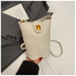 Close-up of cream-white bucket bag featuring lychee grain leather and gold metal lock