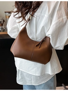 Minimalist dark brown leather shoulder bag in half-moon hobo style for elegant women