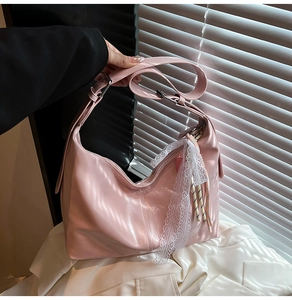 Detailed view of pink moon bag with lace charms and natural light shutter shadow