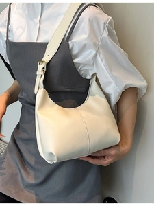 Minimalist creamy white leather hobo bag with adjustable strap and golden buckle