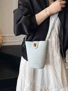 Minimalist light blue bucket bag in lychee pattern leather with golden metal buckle