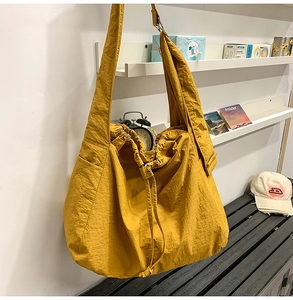 Détail du sac à bandoulière jaune gingembre à cordon et tissu à texture froissée