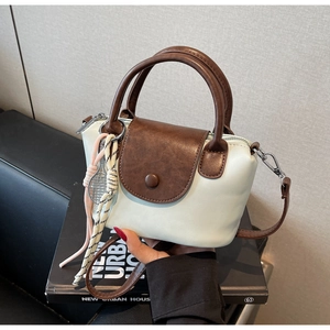 Mini crossbody bag featuring blue PU leather body and brown textured flap detail