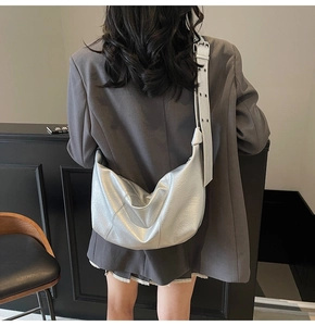 Detailed back view of a silver metallic hobo bag with wide adjustable shoulder strap