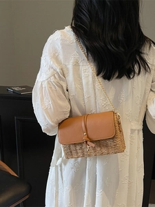Bohemian straw crossbody bag with brown leather flap and elegant gold chain strap