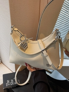 Chic beige lychee leather crescent shoulder bag with heart charm for modern daily use