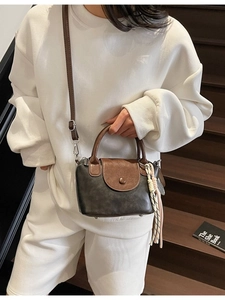 Mini brown and black faux leather crossbody bag with stylish woven tassel detail