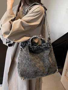 Retro washed denim canvas tote bag with striped shoulder strap worn by a model