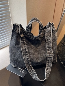 Vintage acid wash denim tote bag with adjustable shoulder strap and metal buckle