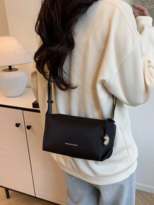 Petit sac carré noir minimaliste avec texte imprimé et pendentif en métal pour femme