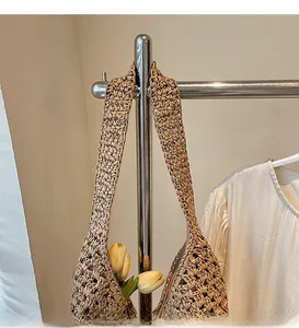Detailed view of handwoven straw bucket bag with intricate texture and tulip decoration