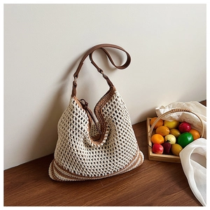 Detailed close-up of handmade woven tote bag with brown leather strap and mesh pattern