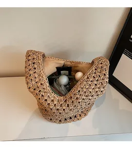 Spacious interior of woven straw bucket bag showing storage capacity for daily essentials