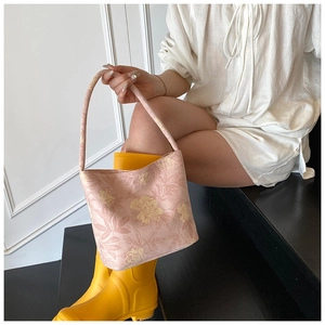 Detail of pink floral jacquard bucket bag with vintage embroidery and fabric handle