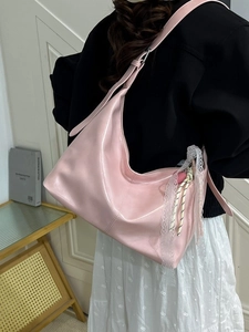 Pink glossy hobo bag with lace trim and shoulder strap for a sweet casual style