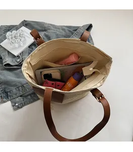 Detailed interior of a large straw tote bag showing spacious storage for daily items