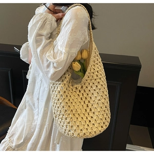 Detail showing the intricate hollow crochet weave of this beige large capacity beach tote