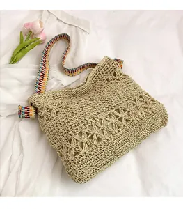Detailed crochet texture and colorful ethnic strap of a beige woven tote shoulder bag