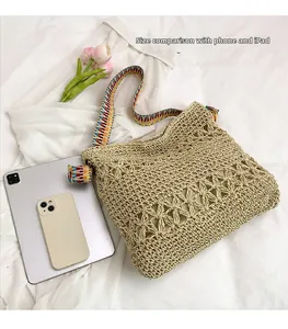 Detailed view of woven straw tote bag with ethnic strap next to iPad for size comparison