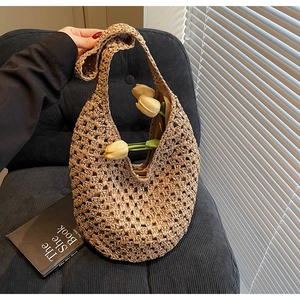 Detailed hollow woven texture of straw tote bag with elegant crochet pattern design