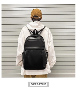 Rear view of a model wearing a black large-capacity minimalist PU leather backpack