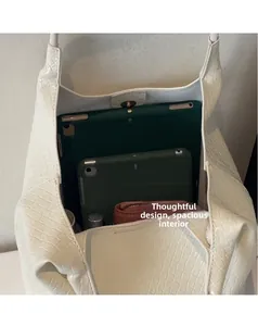 Top view showing spacious interior of the white tote bag with tablets and wallet