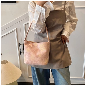 Close-up of pink floral jacquard fabric on a stylish tote bag with shoulder straps