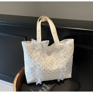 Détails du sac cabas en toile à pois avec froufrous en dentelle et nœud élégant