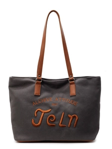 Grey canvas tote bag with brown leather handles and orange letter embroidery