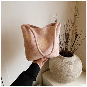 Detailed close-up of a pink floral tote bag with linen texture and sturdy double handles
